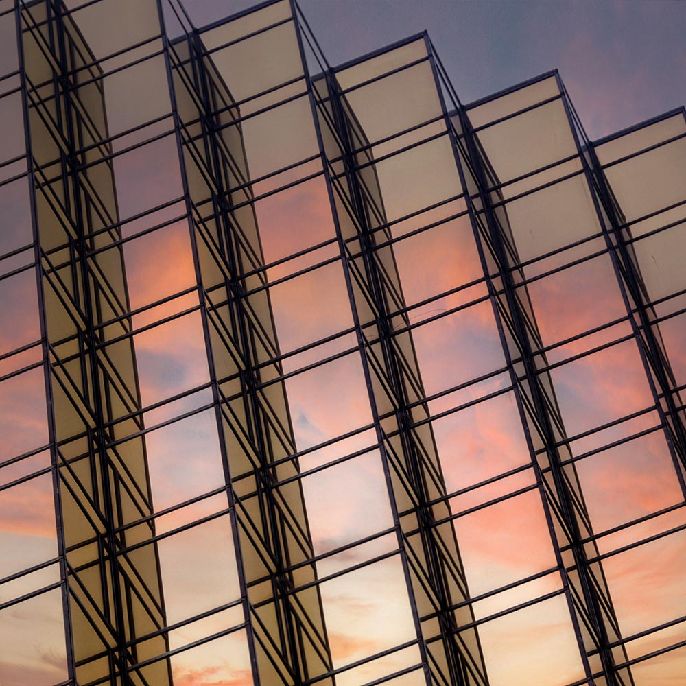 windows of a skyscraper reflecting the sunset