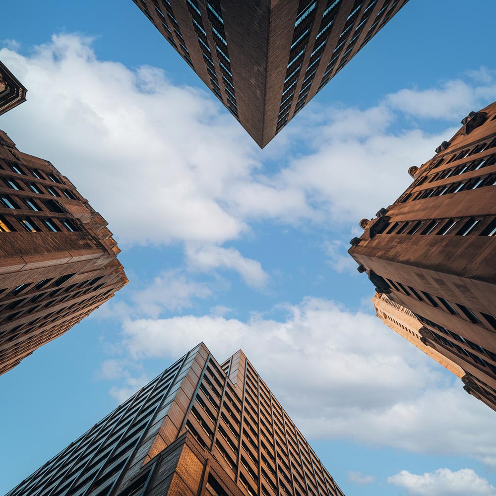 looking up through skyscrapers to the sky