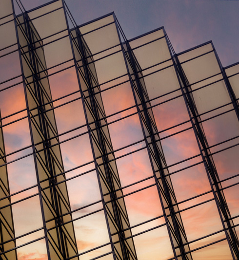 windows of a skyscraper reflecting the sunset